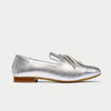 Silver loafer with tassel on a light gray background