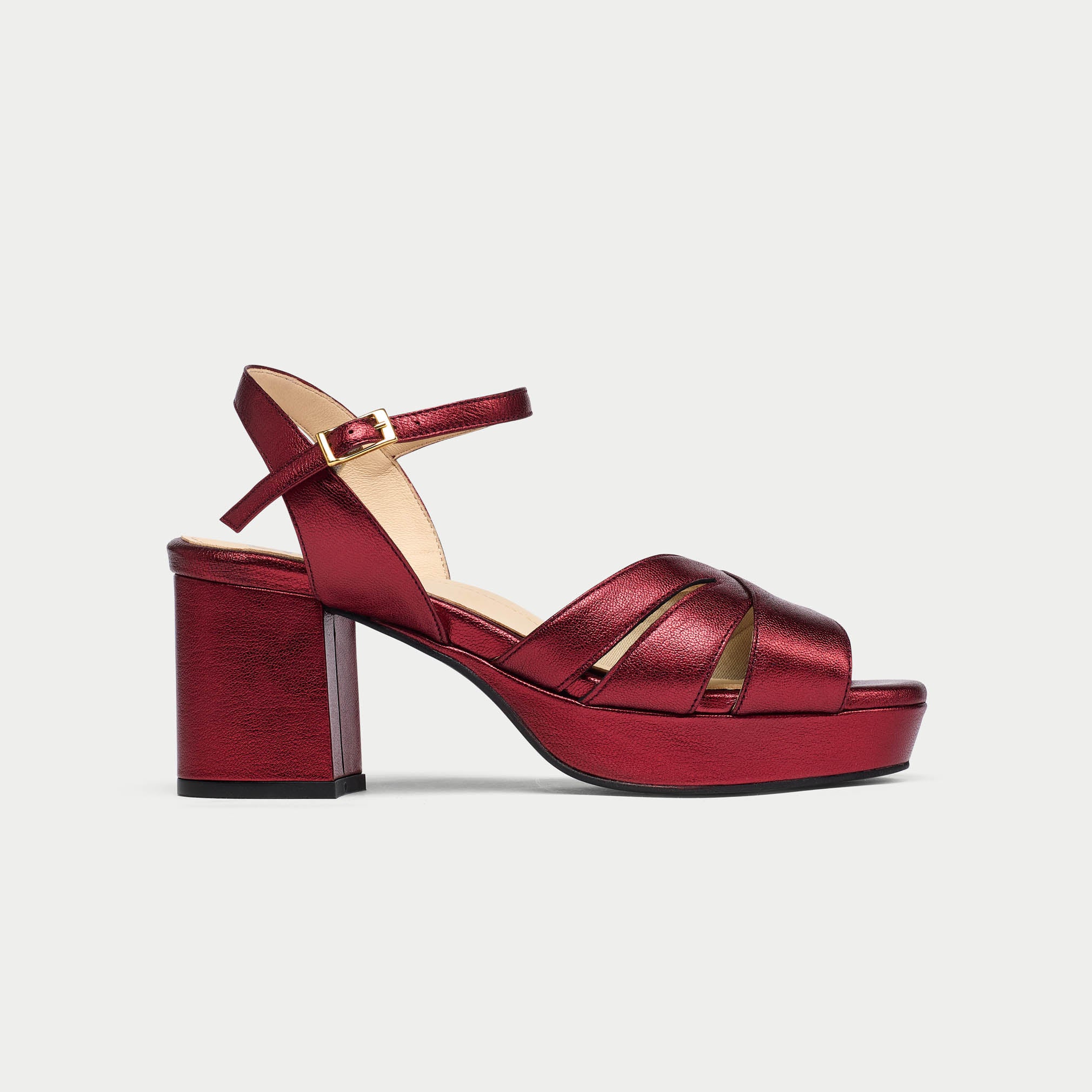 Red high-heeled sandal on a light gray background