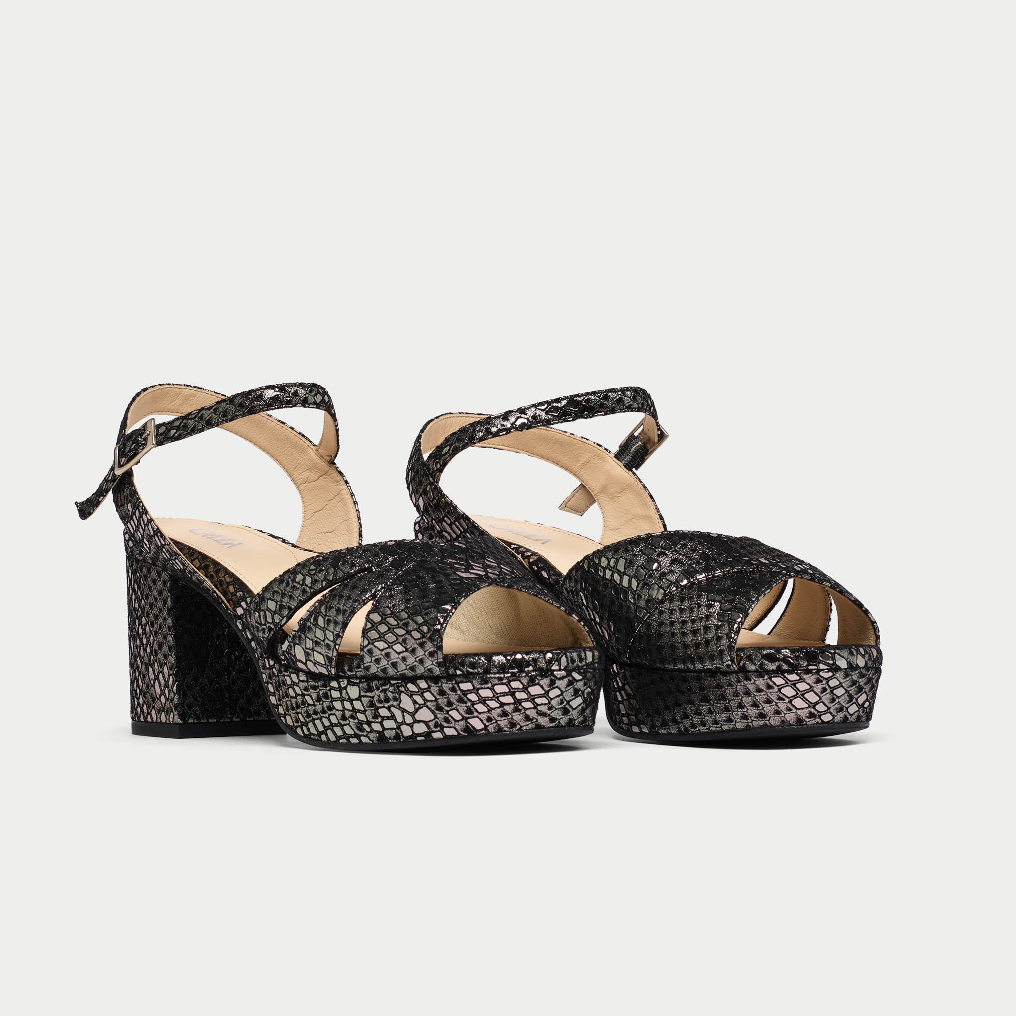 Black woven platform sandals on a light gray background