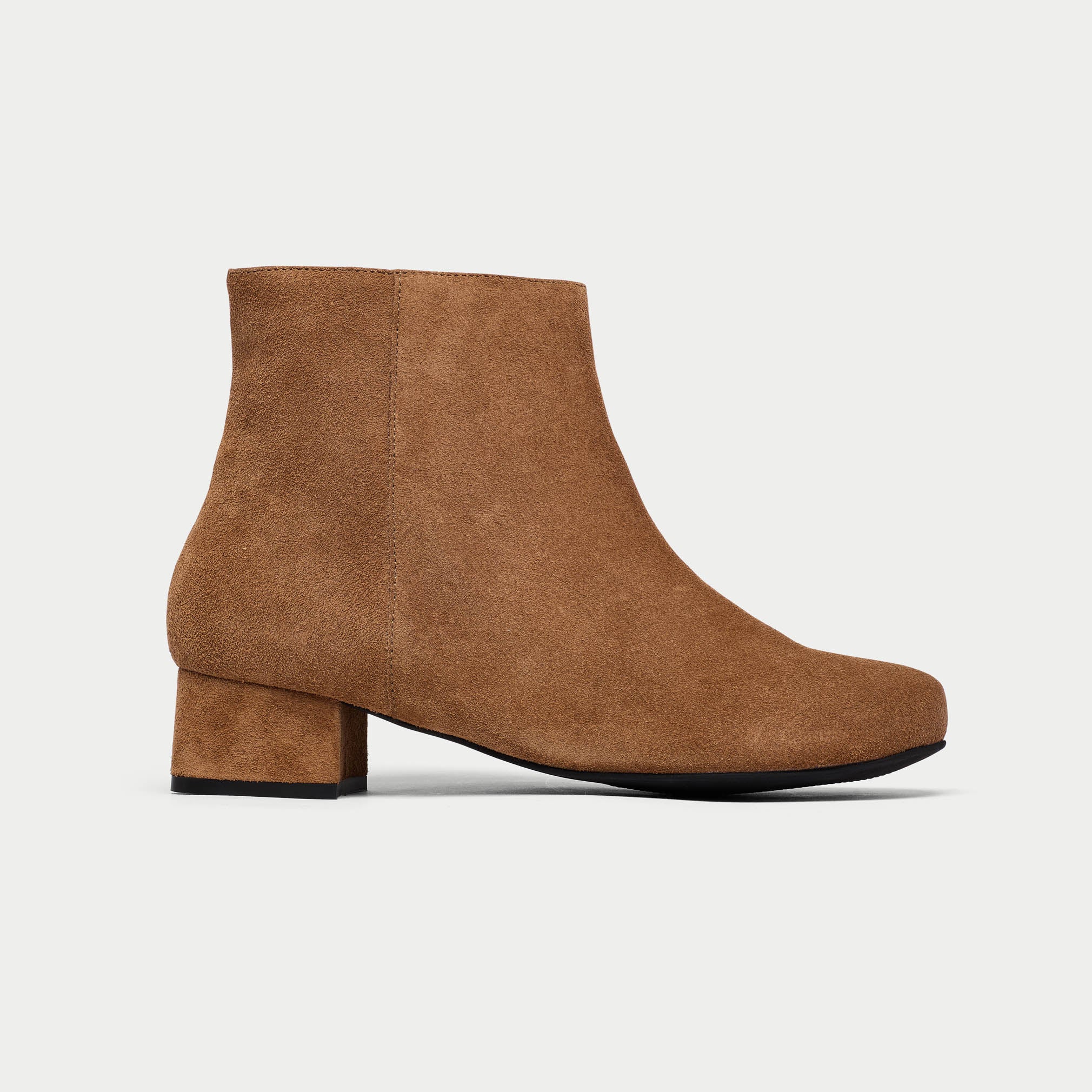 Brown suede ankle boot on a light gray background