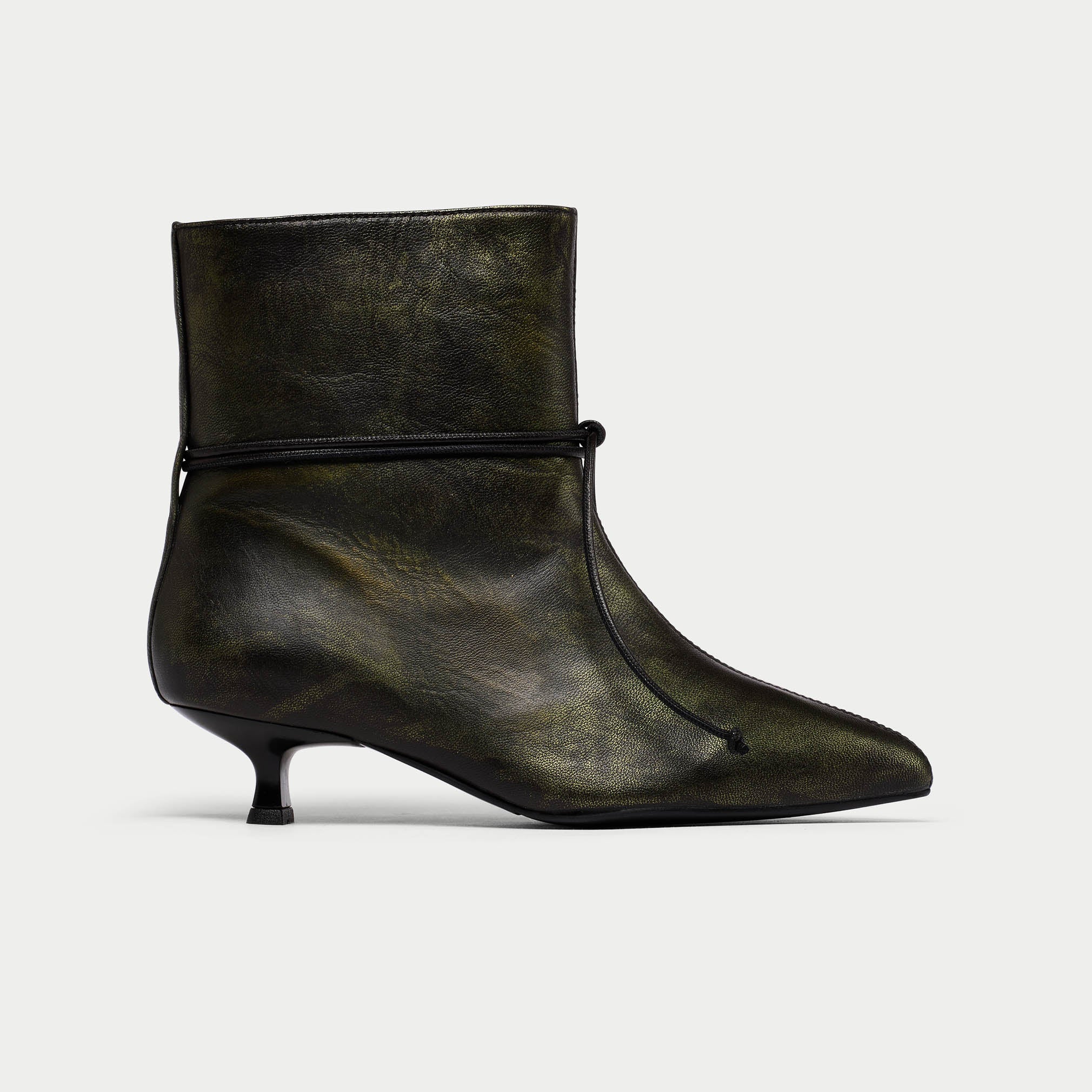 Black leather ankle boot with a pointed toe on a light gray background