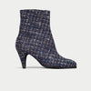 Navy blue tweed ankle boot on a light gray background