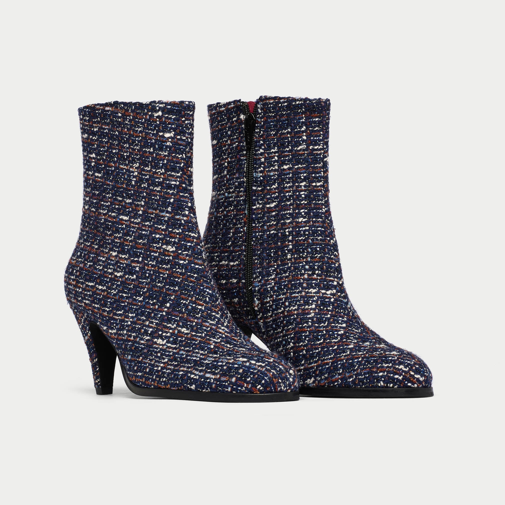 Pair of Maya tweed ankle boots on a light gray background
