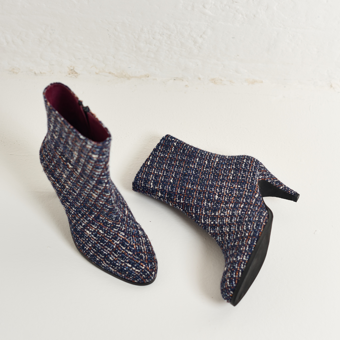 Pair of Maya tweed ankle boots on a light background