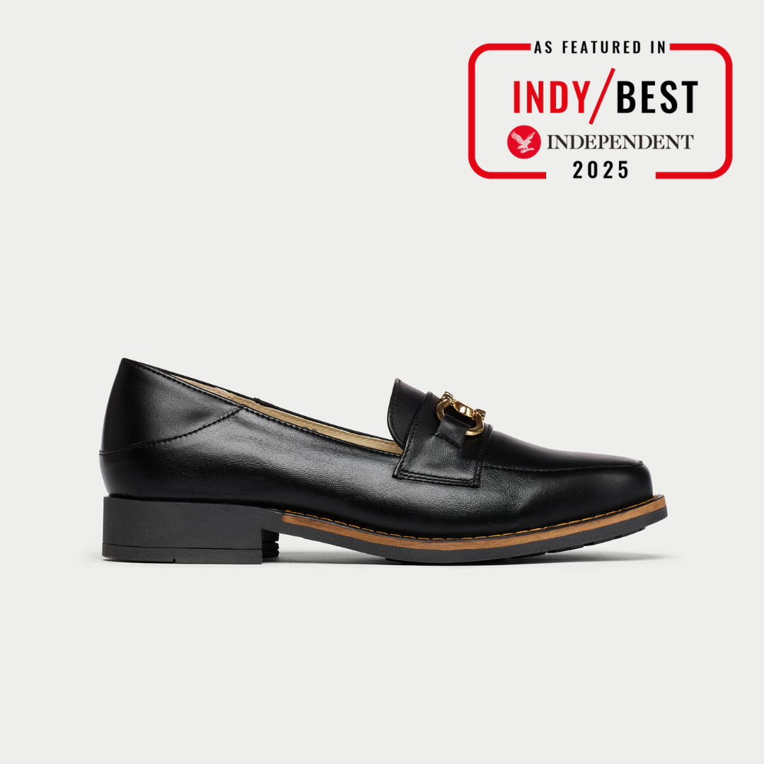 Black leather loafer with gold buckle on a white background, featuring Indy Best Independent 2025 badge.