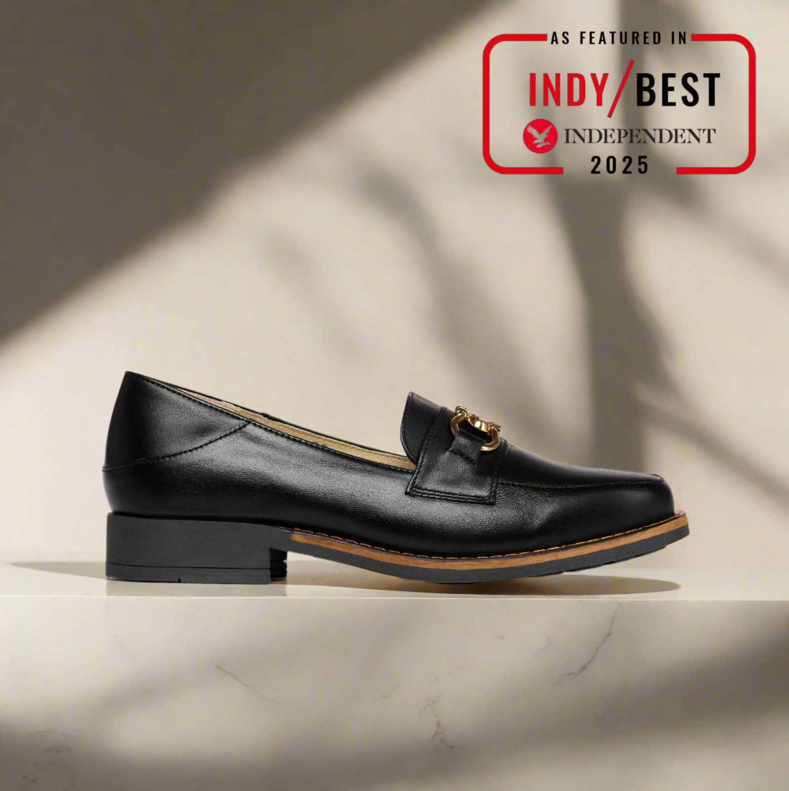 Black leather loafer shoe on a light background with 'Indy Best Independent 2025' badge.