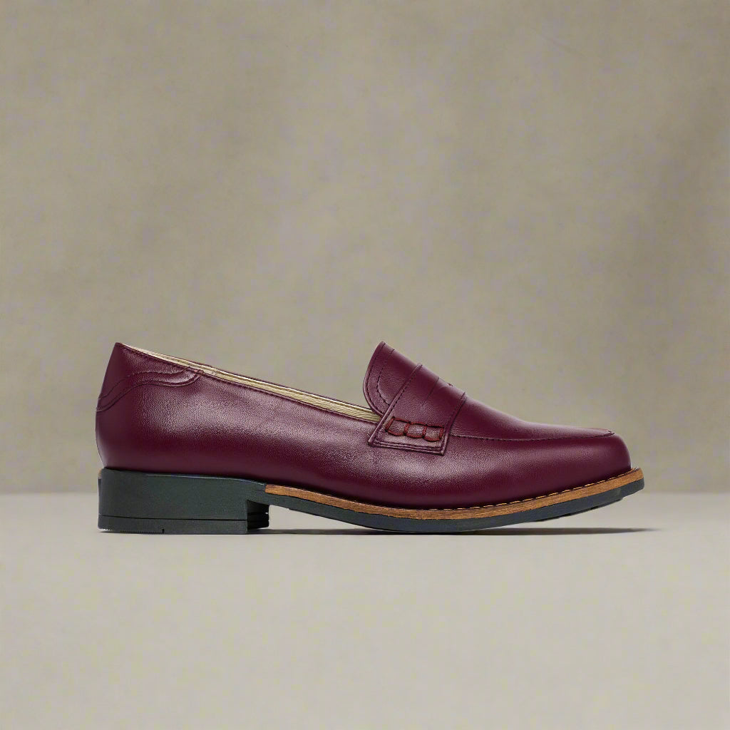 Cherry Nadia leather loafer on a light beige background