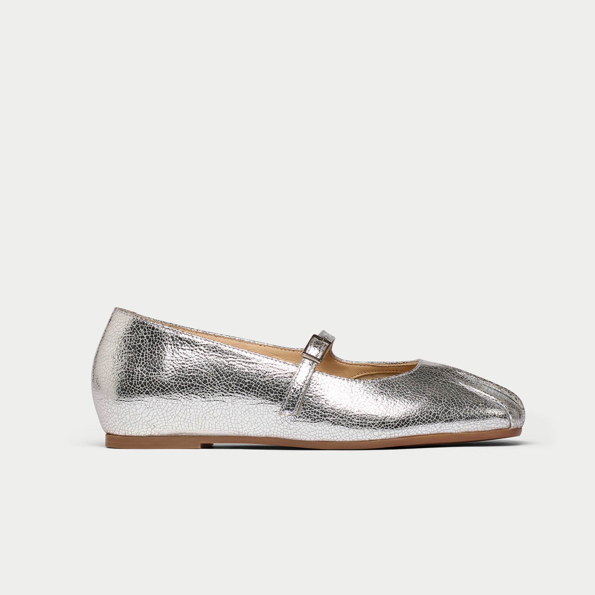 Silver metallic flat shoe on a white background