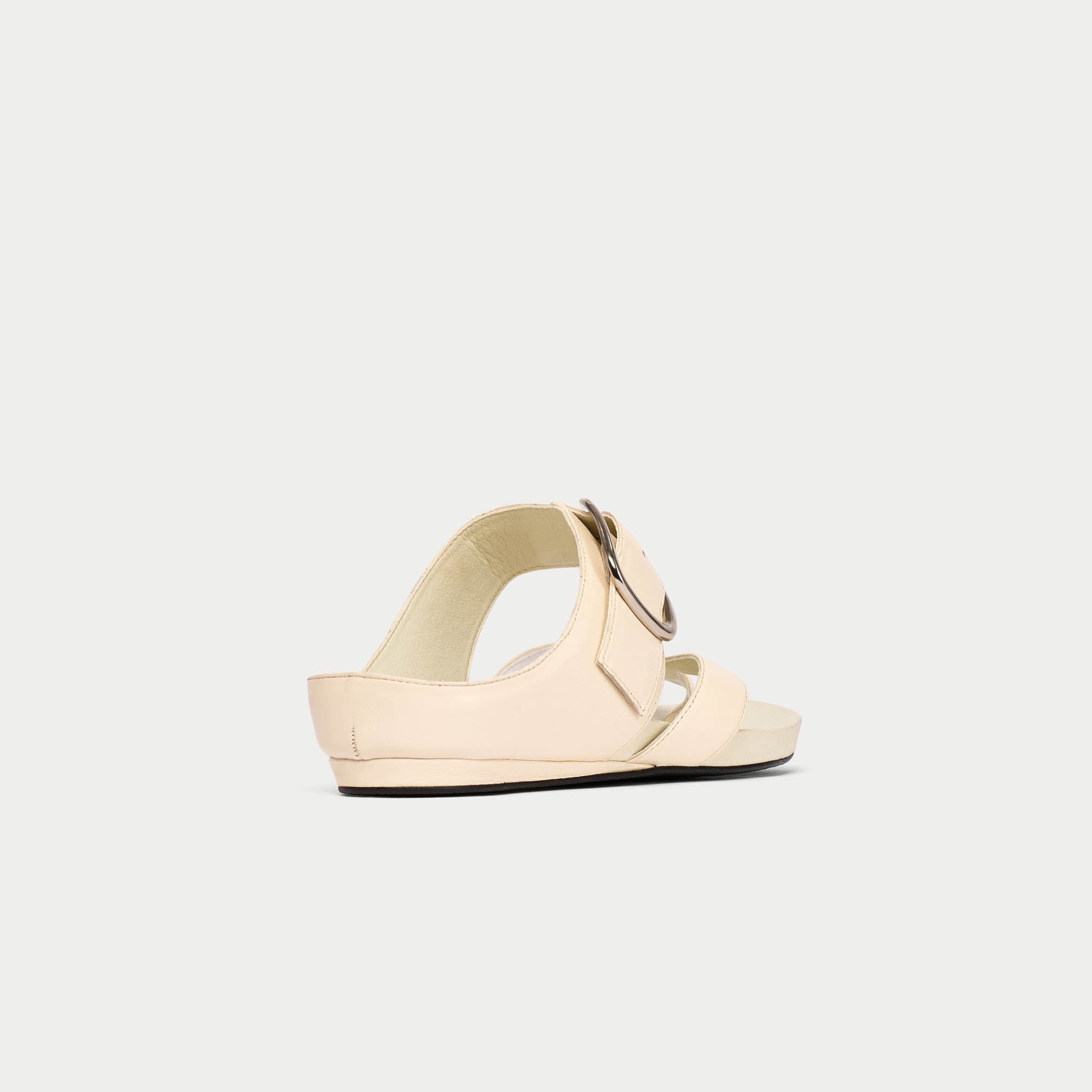 Beige sandal with a strap on a light gray background