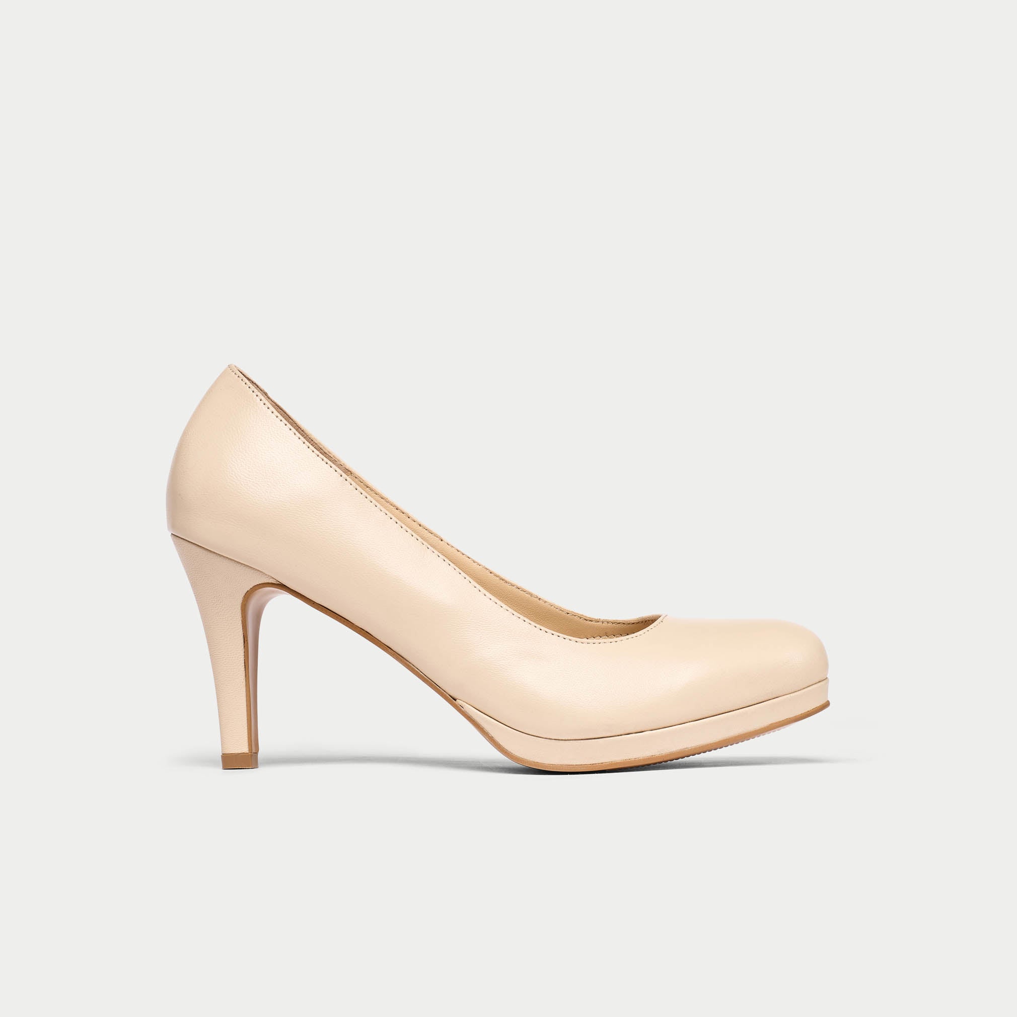 Beige high-heeled shoe on a light gray background