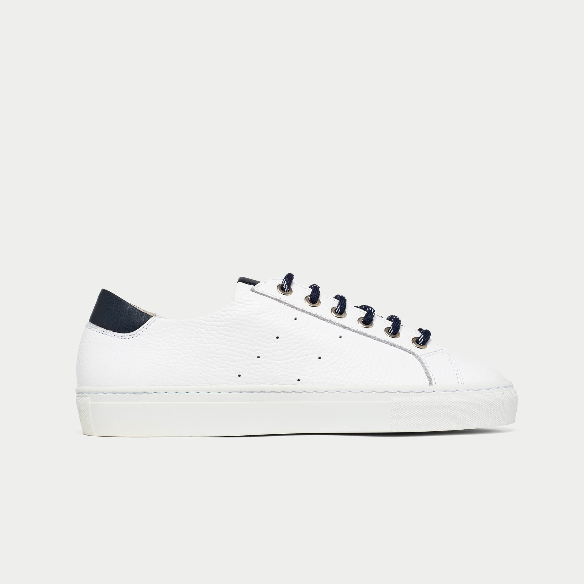 White sneaker with navy accents on a light gray background
