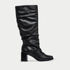 Black knee-high boot on a light gray background