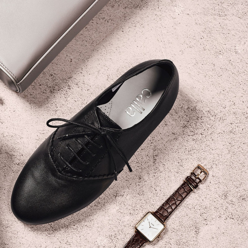 black leather brogue shoes paired with a watch