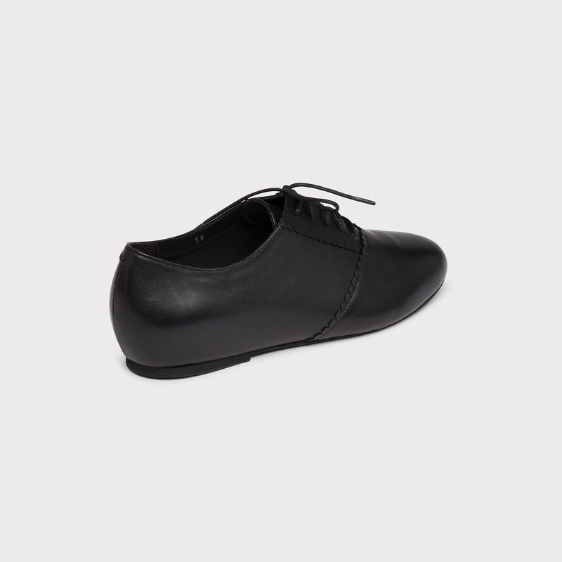 black leather flat brogue back view